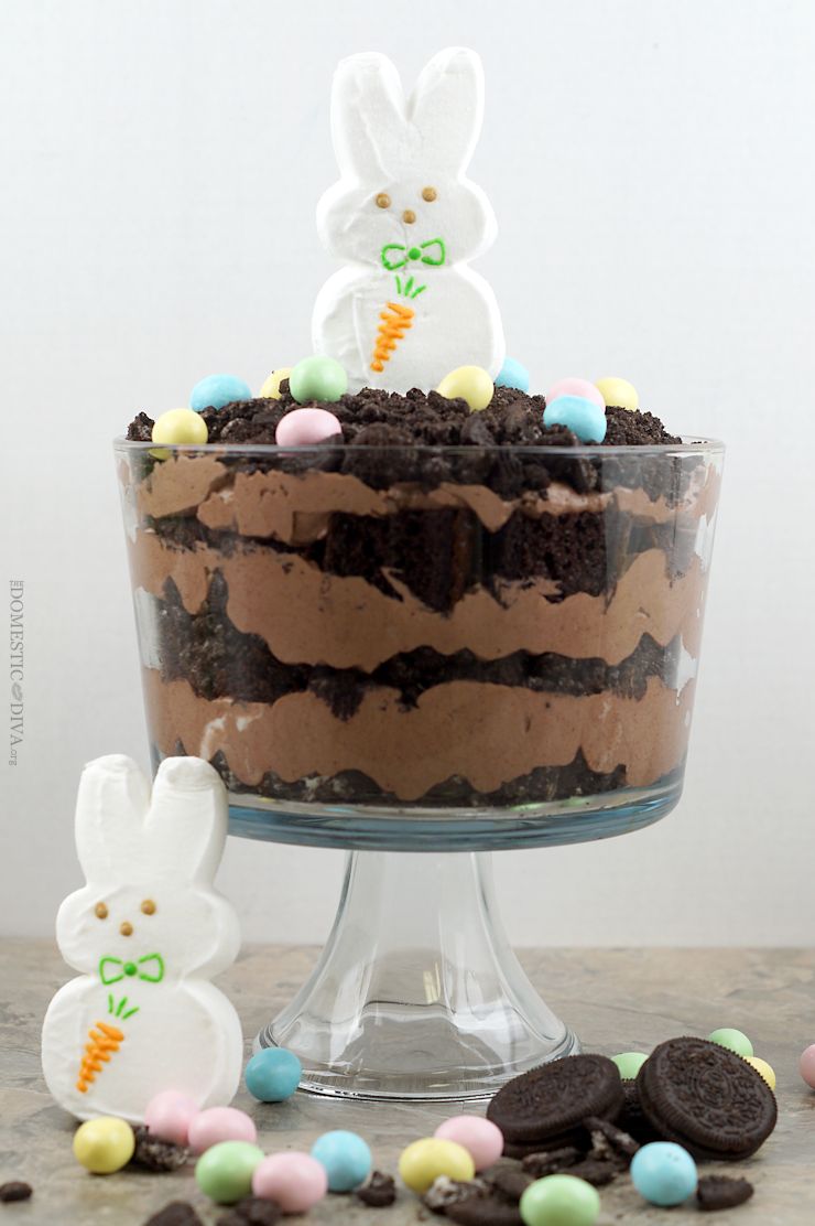 Easter Bunny Dirt Cake Trifle Recipe: Rich chocolatey cake trifle with decadent layers of chocolate pudding and crushed oreos. Top this trifle with Easter themed edible decorations like a marshmallow bunny and milk chocolate candy coated eggs and you have a dessert everyone will be talking about.